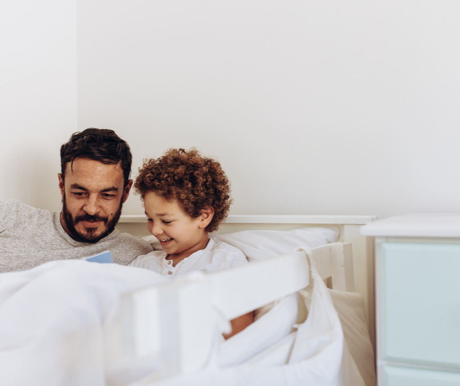 child falling asleep to story with dad