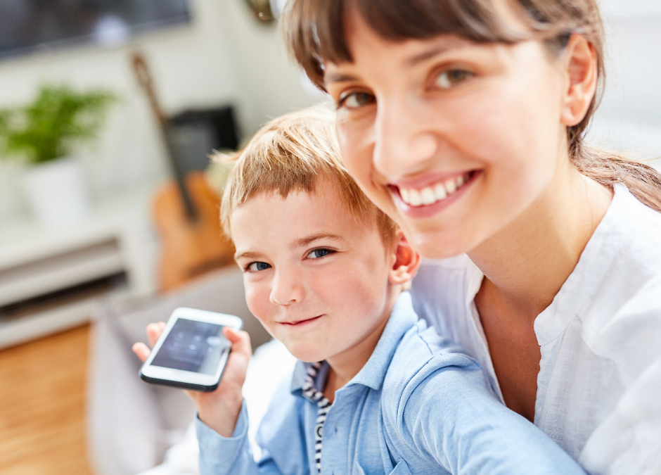 Child holding phone with new babysitter